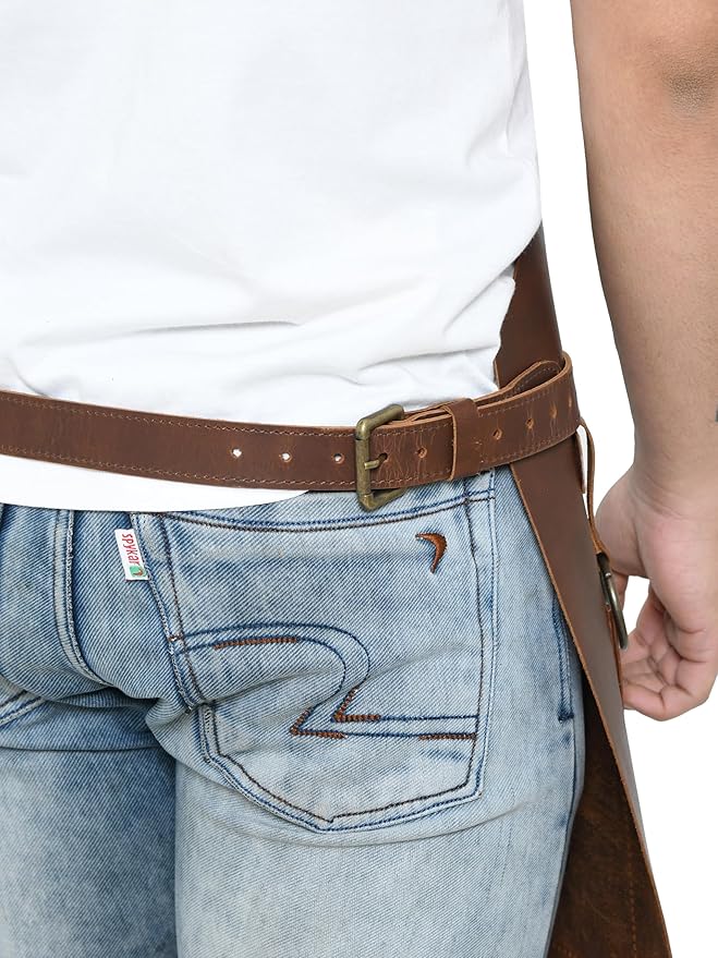 Rear close-up of adjustable leather waist strap and brass buckle on brown work apron