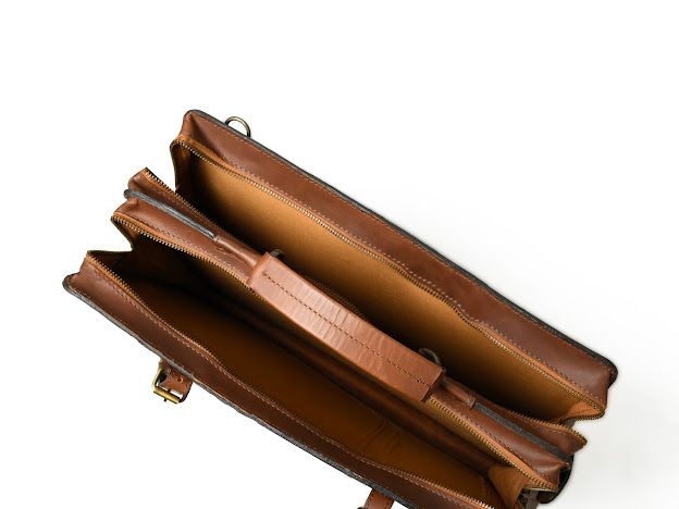 Open dark brown Sable leather work briefcase showing cotton-lined interior and storage compartments