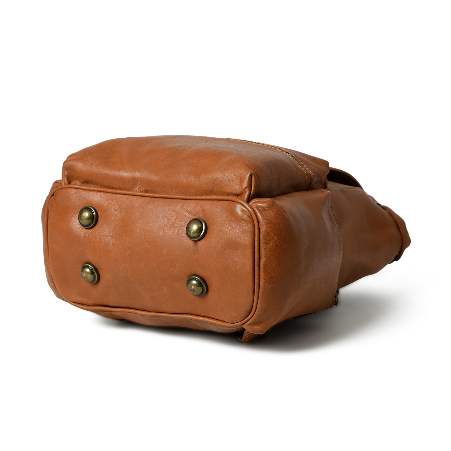 Cognac Vivian leather backpack, bottom view showing reinforced base and four antique-tone metal feet