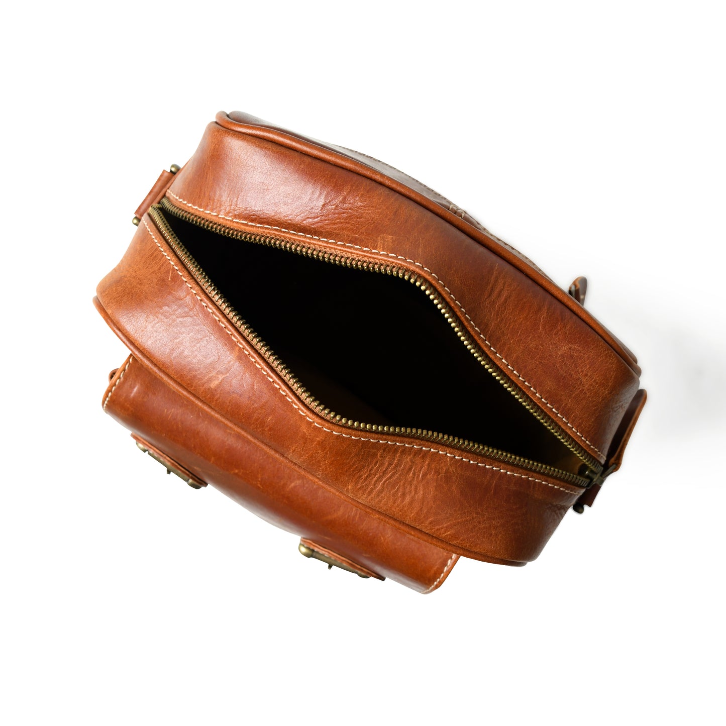 Open waxed buffalo leather crossbody bag showing the lined interior and storage compartments