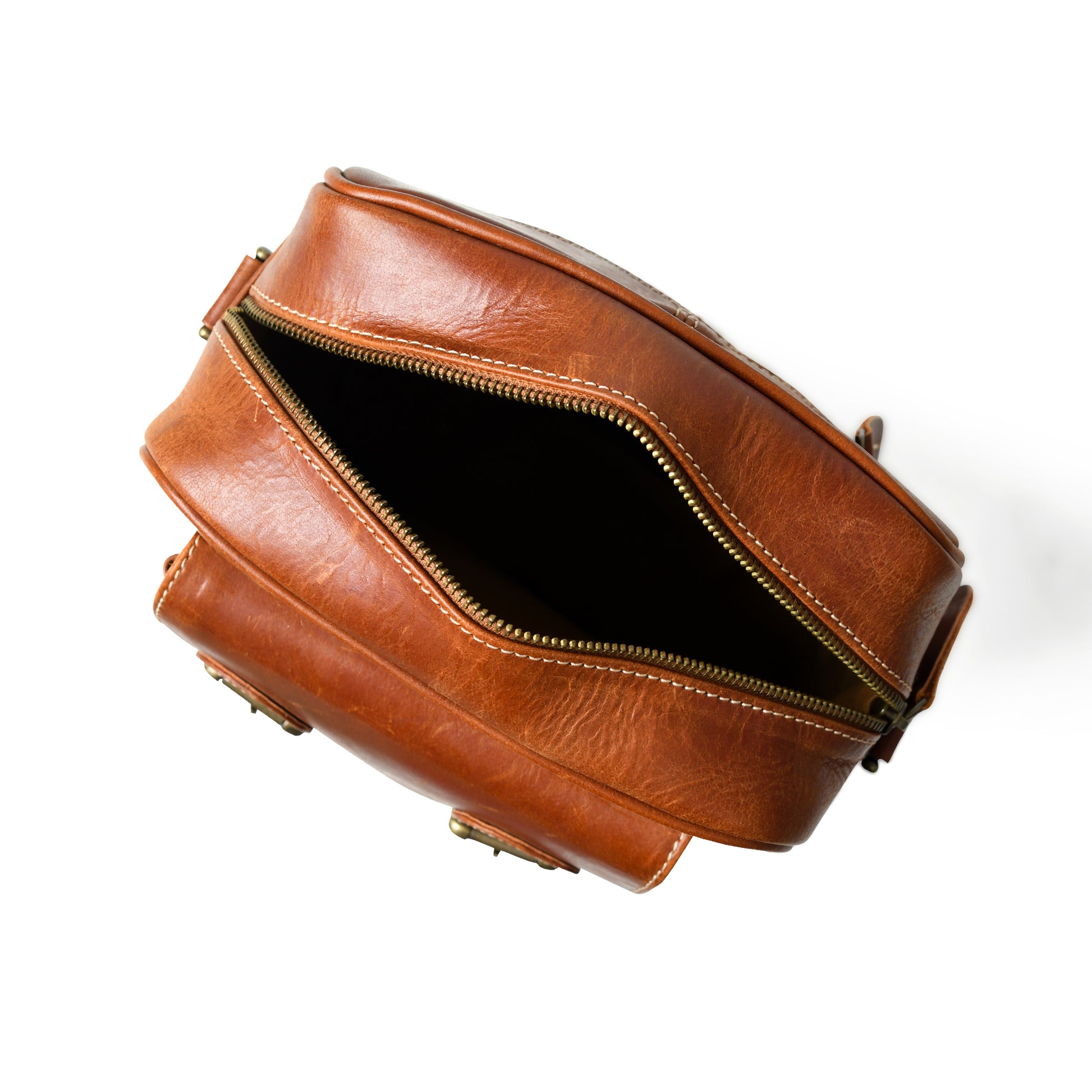 Open waxed buffalo leather crossbody bag showing the lined interior and storage compartments