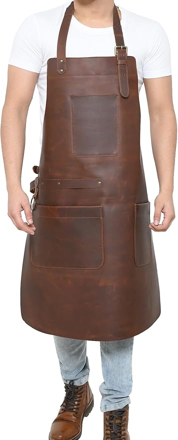 Person wearing a brown full-grain leather work apron with multiple tool pockets and adjustable shoulder straps