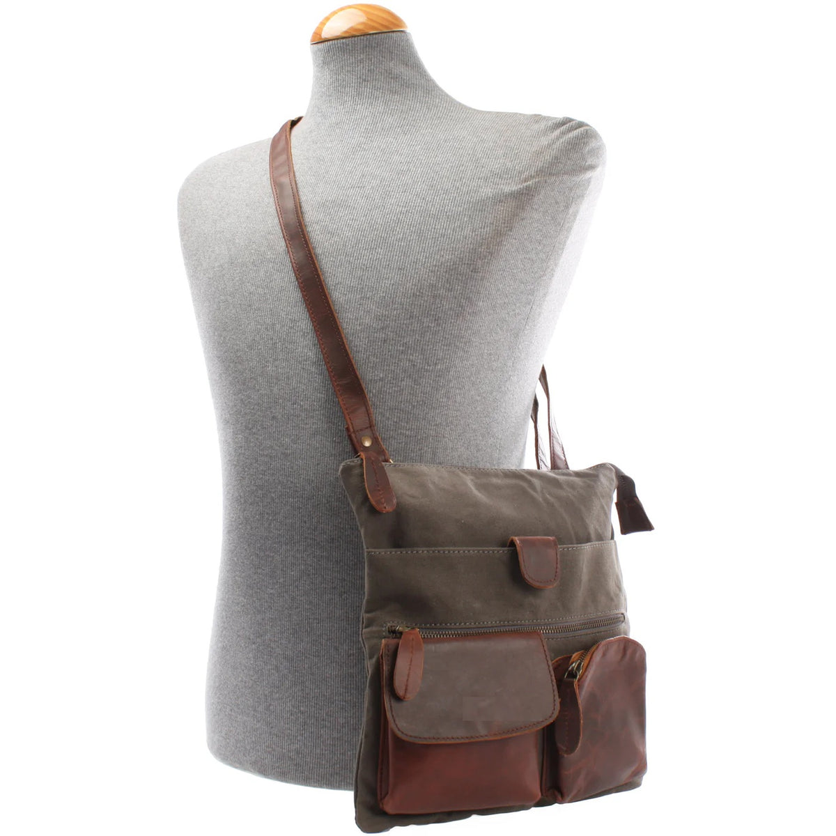 Gray Arden canvas and cowhide crossbody bag worn on a mannequin, showing size and adjustable strap