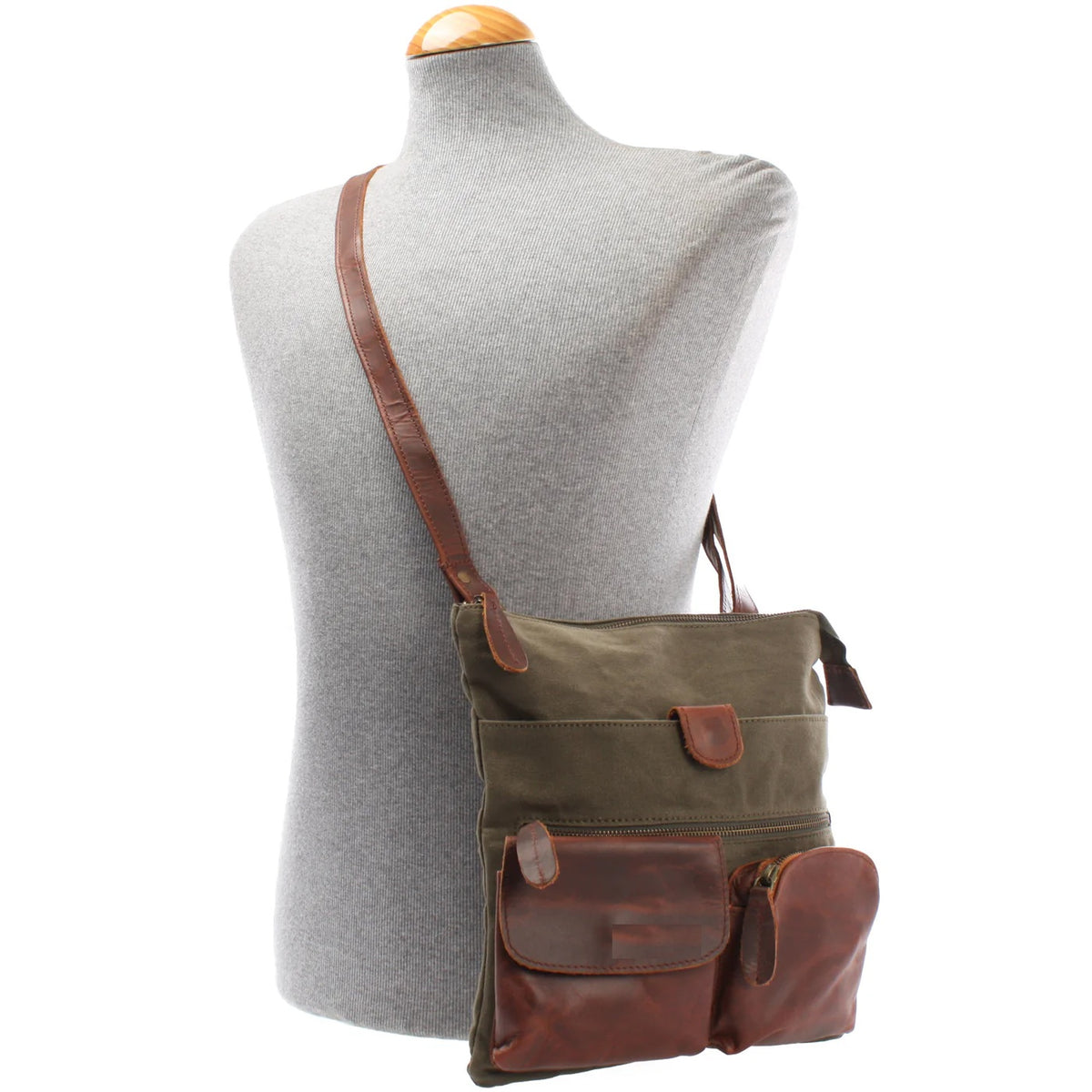Olive green Arden canvas and cowhide crossbody bag worn on a mannequin, showing size and adjustable strap