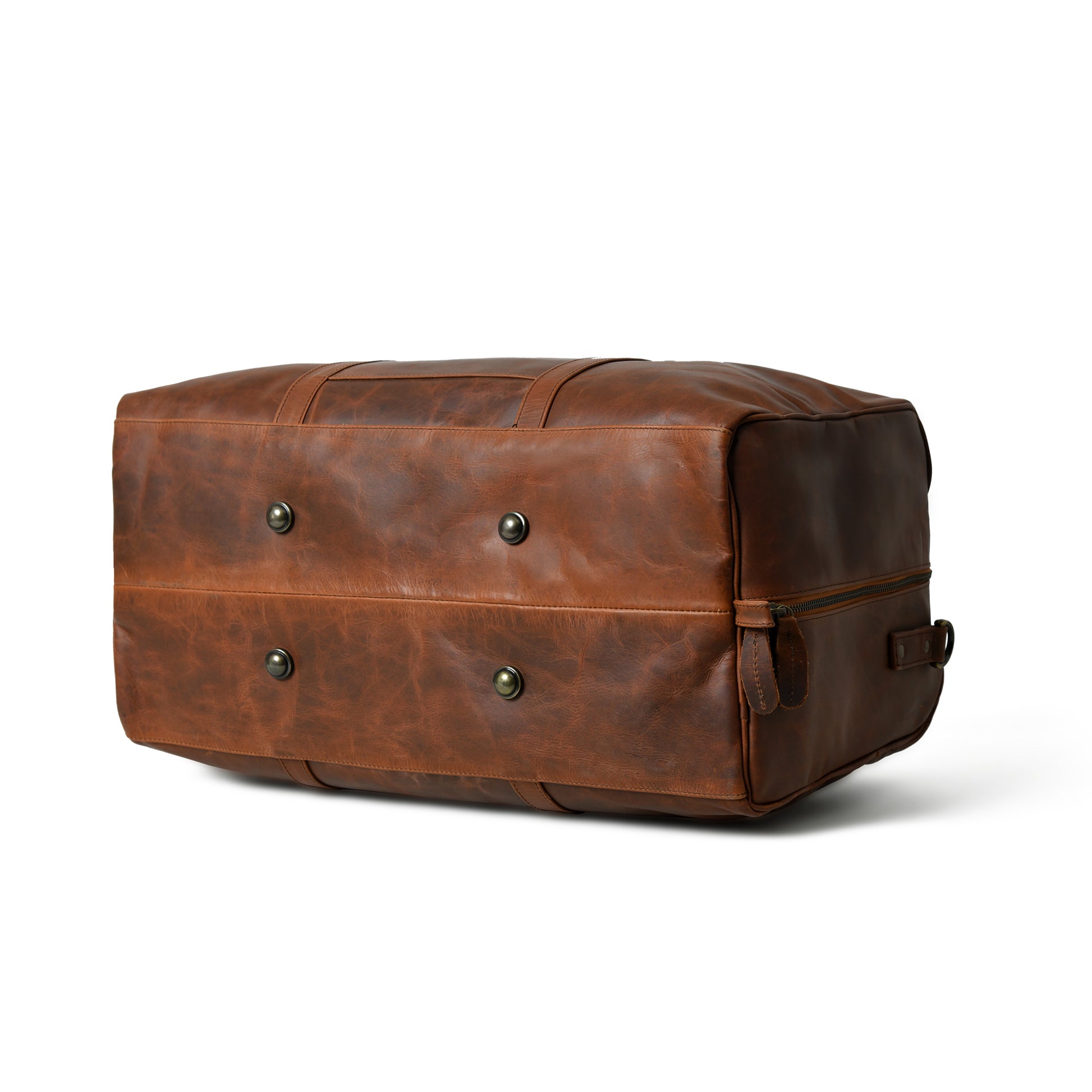 A brown distressed leather duffel bag with brass snap buttons and a zippered side pocket, shown on a clean white background.