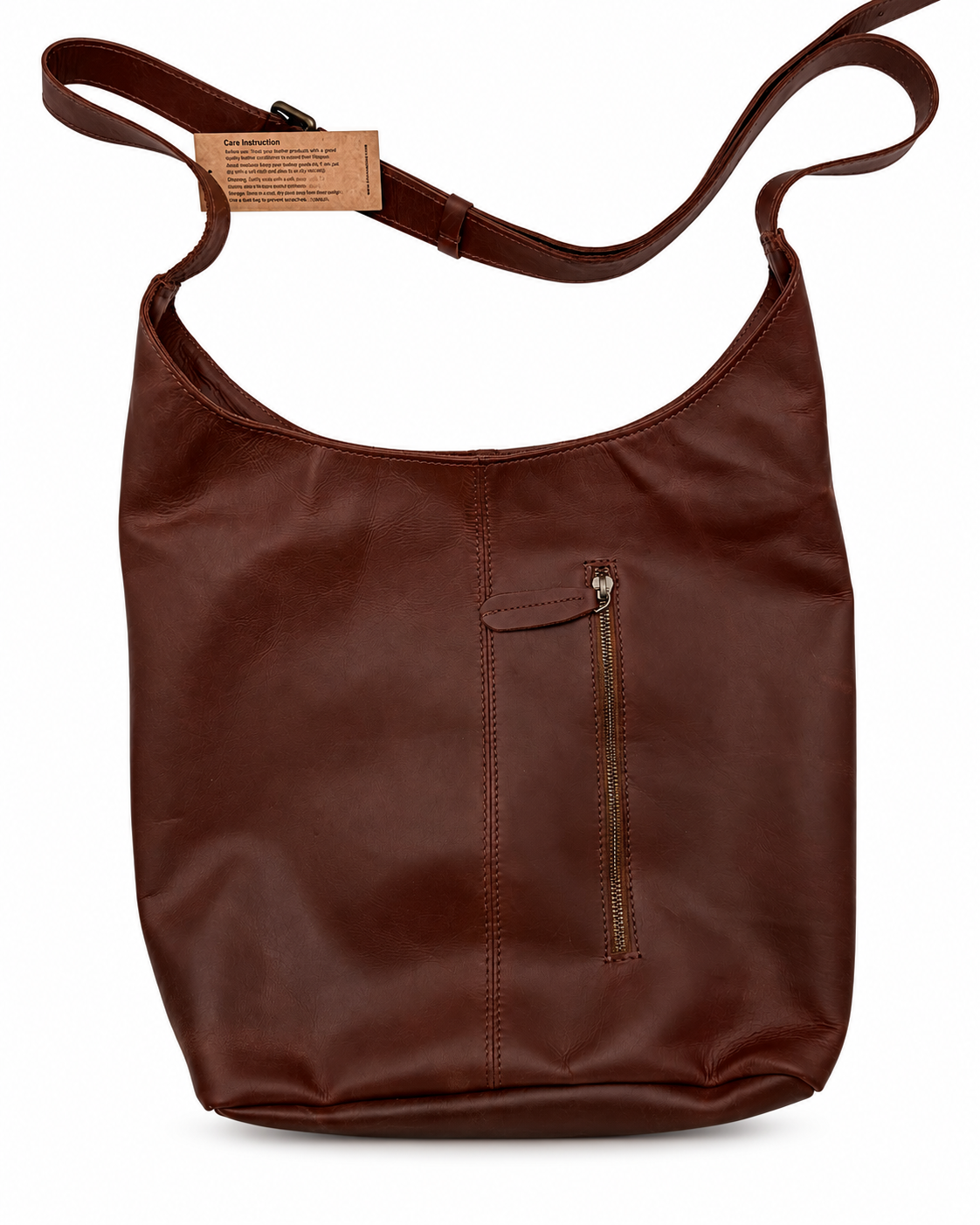 A dark brown handmade full-grain leather shoulder bag with a single shoulder strap, a vertical front zip pocket, and a small tan paper brand tag attached near the strap, shown on a plain white background.