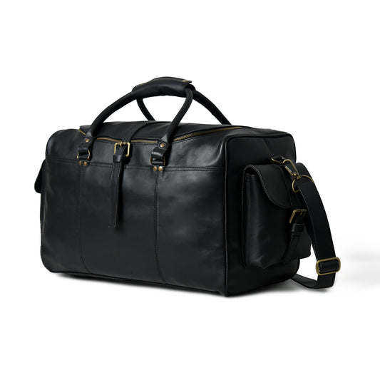 A black leather duffel bag with gold-tone hardware, dual top handles, a detachable shoulder strap, and a zippered main compartment, shown on a white background.