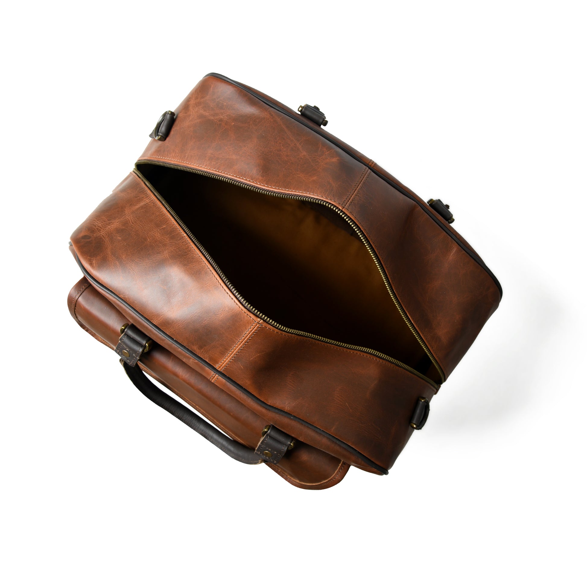 A brown distressed leather briefcase shown from an overhead angle with its main compartment open, revealing a dark interior, on a white background.