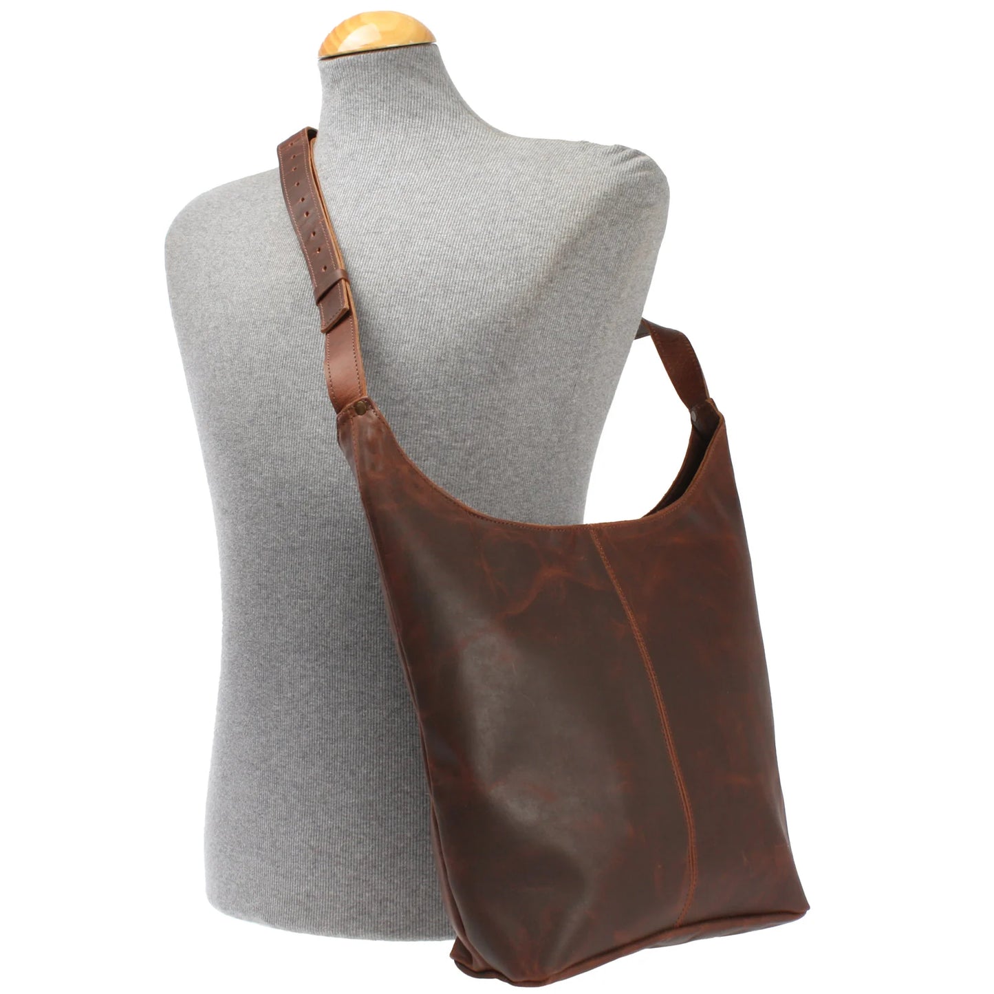 Brown Elaine waxed leather shoulder bag worn on a mannequin, showing size and adjustable strap