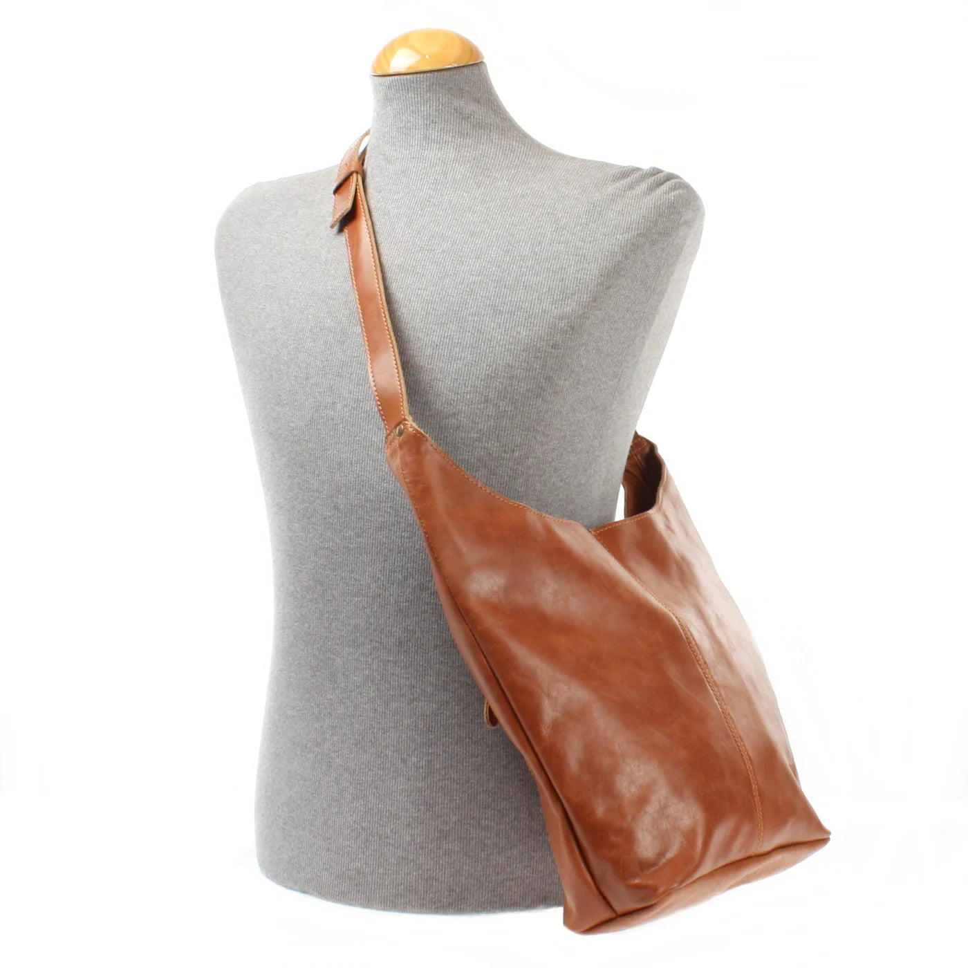 Cognac Elaine leather shoulder bag worn on a mannequin, showing size and adjustable strap