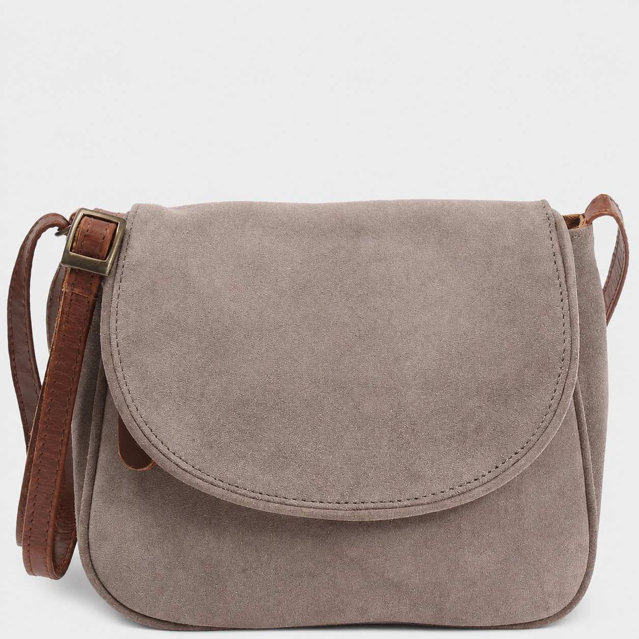 A Cuiravo Elara suede crossbody bag with a brown leather strap and a brass buckle, shown against a plain light gray background.
