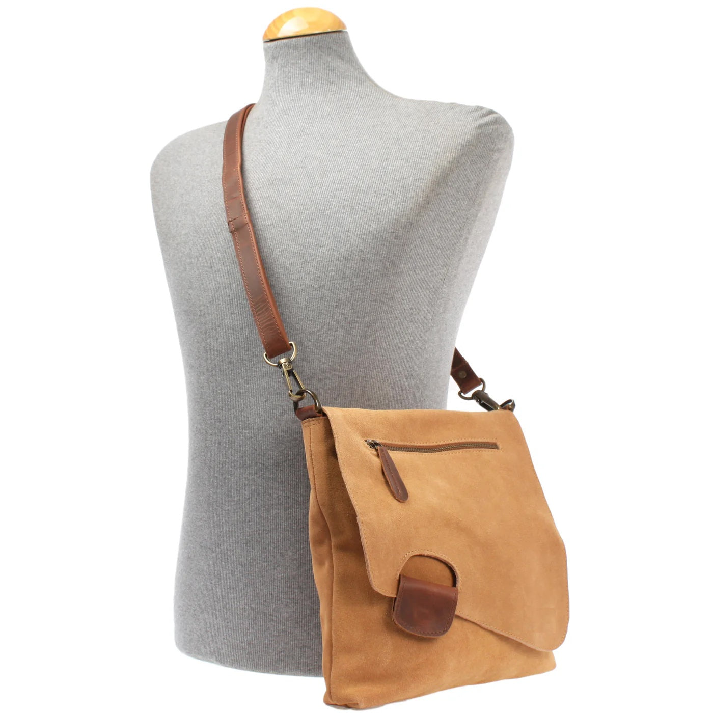 Cognac Mira suede and leather bag worn crossbody on a mannequin, showing size and adjustable strap