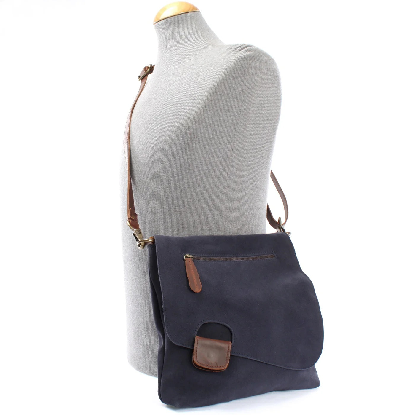 Navy Mira suede and leather bag worn crossbody on a mannequin, showing size and adjustable strap