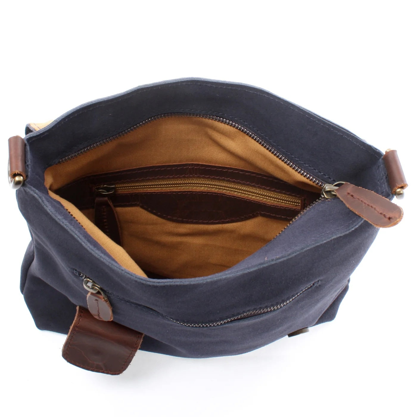 Open navy Mira suede bag showing tan lining, interior zip pocket, slip pocket, and main zipper