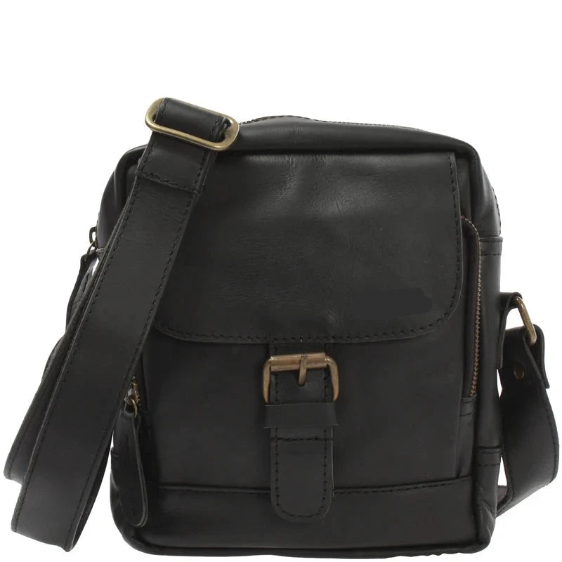 Black Noa waxed leather crossbody bag, front view with flap, brass-tone buckle, side zipper, and wide strap
