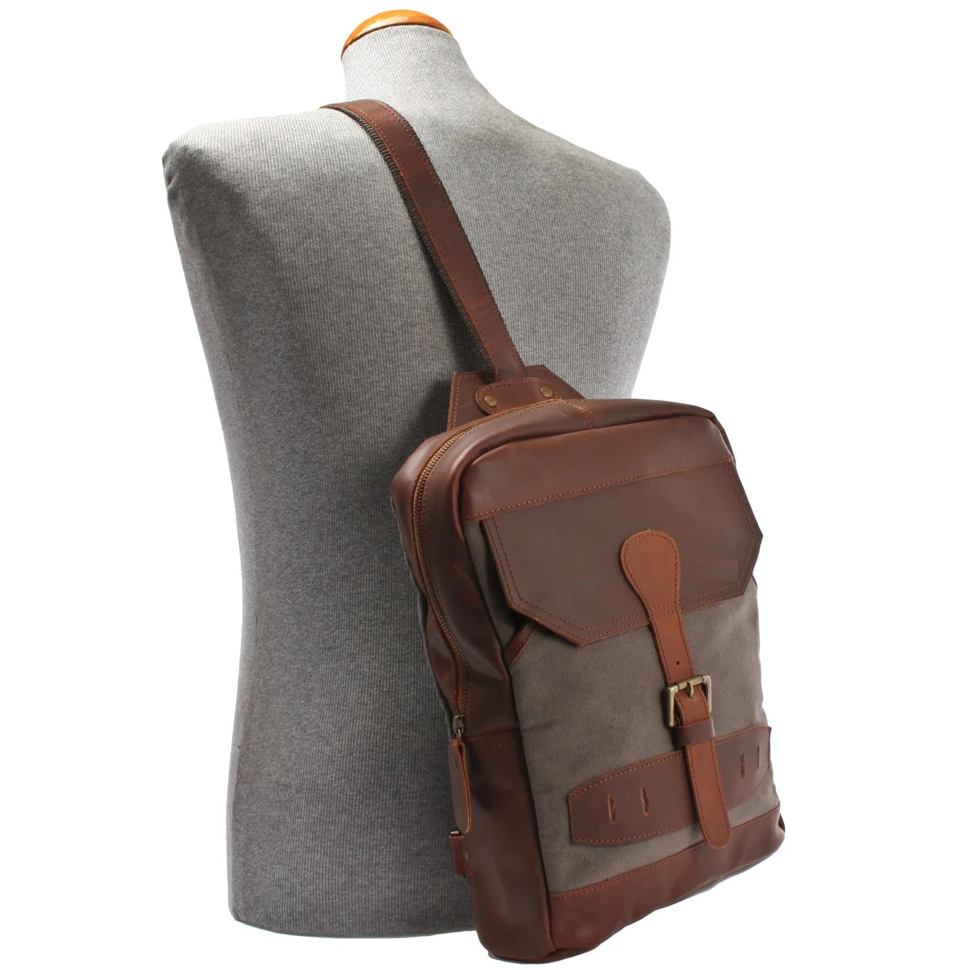 Gray Rowan sling backpack worn crossbody on a mannequin, showing compact scale and adjustable strap
