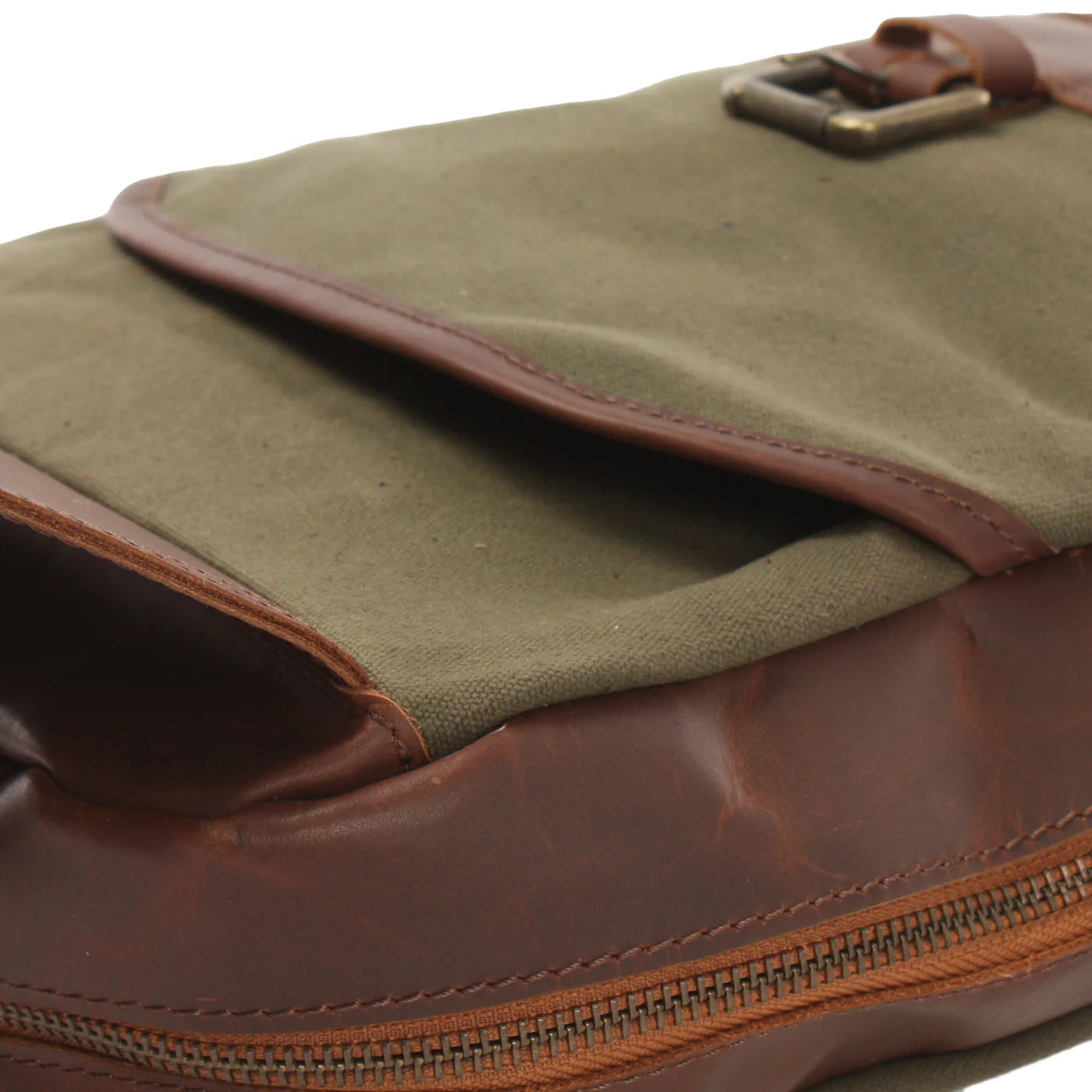 Close-up of olive green Rowan canvas front pocket, leather trim, buckle, and main zipper