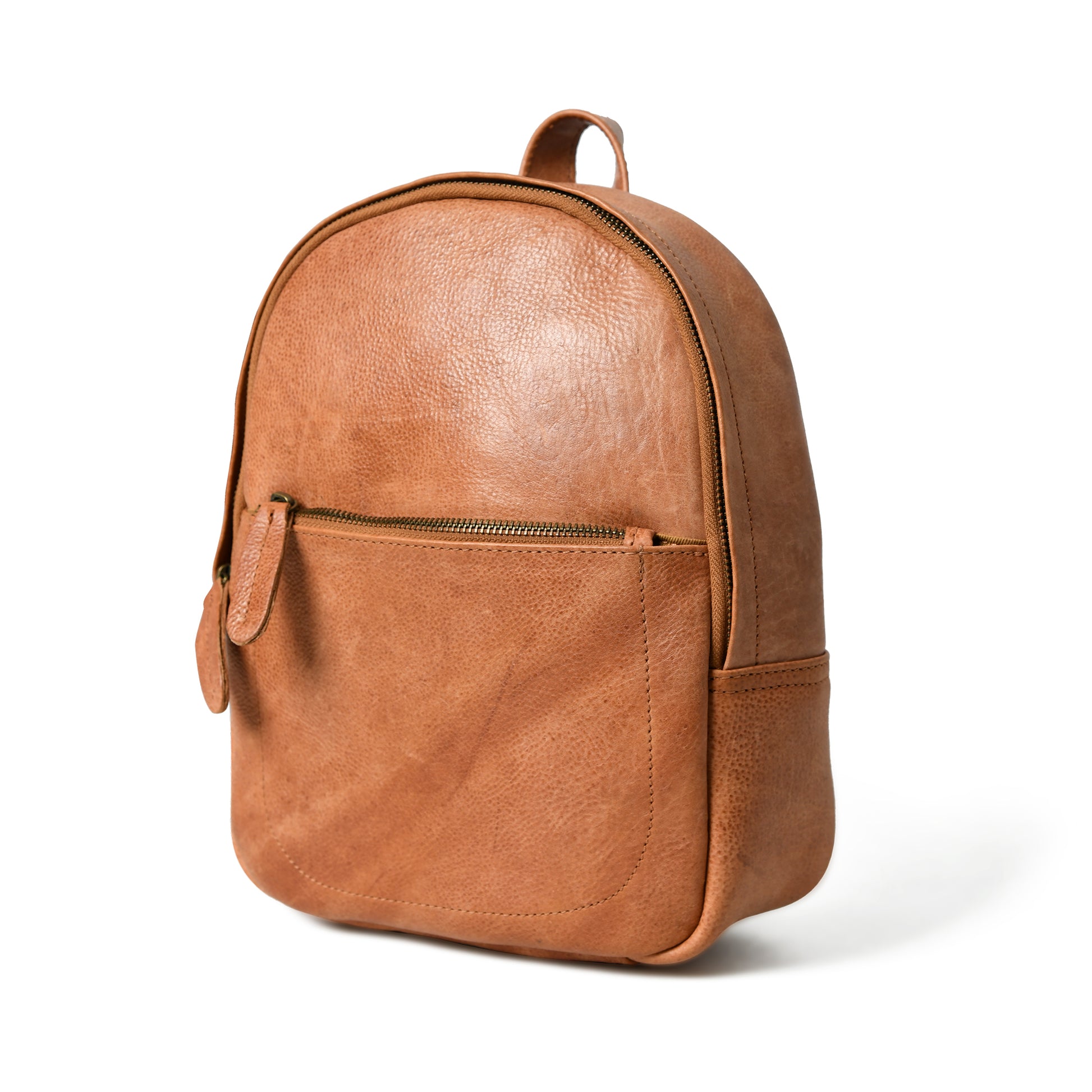 Cognac Sienna leather backpack, angled front view with rounded top, front zip pocket, top handle, and side pocket