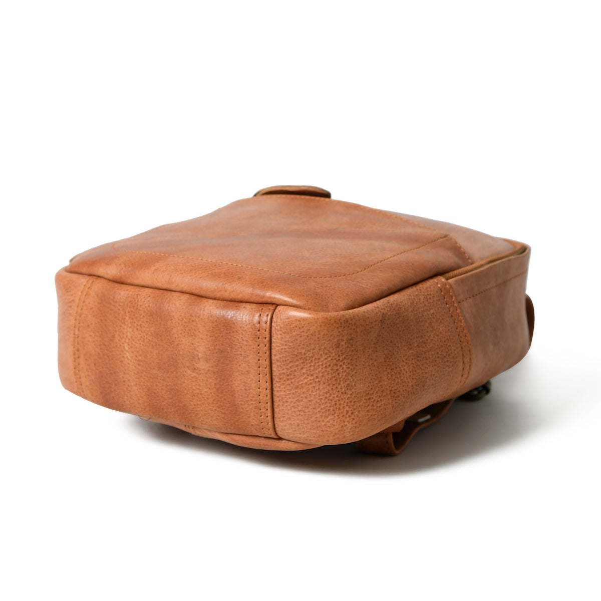 Cognac Sienna leather backpack, bottom view showing smooth reinforced base and rounded corner stitching