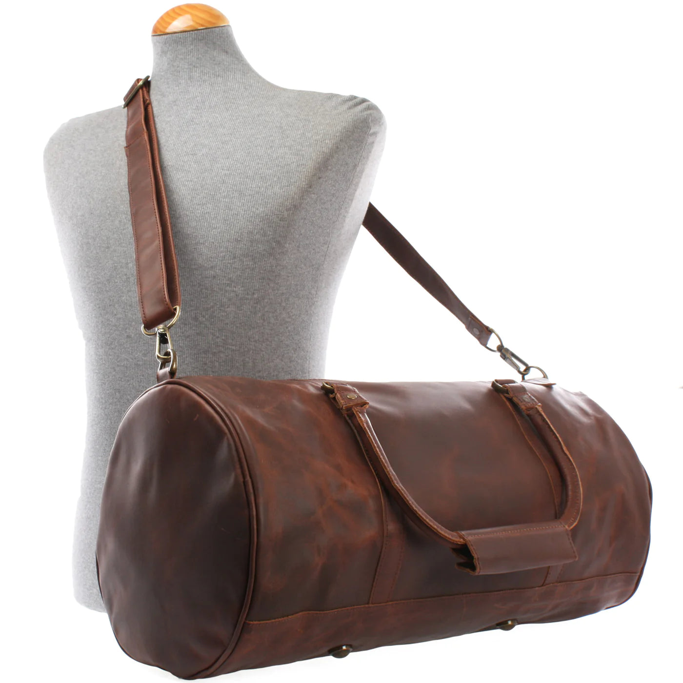 Brown Voyager leather weekender duffel displayed on a mannequin with detachable shoulder strap