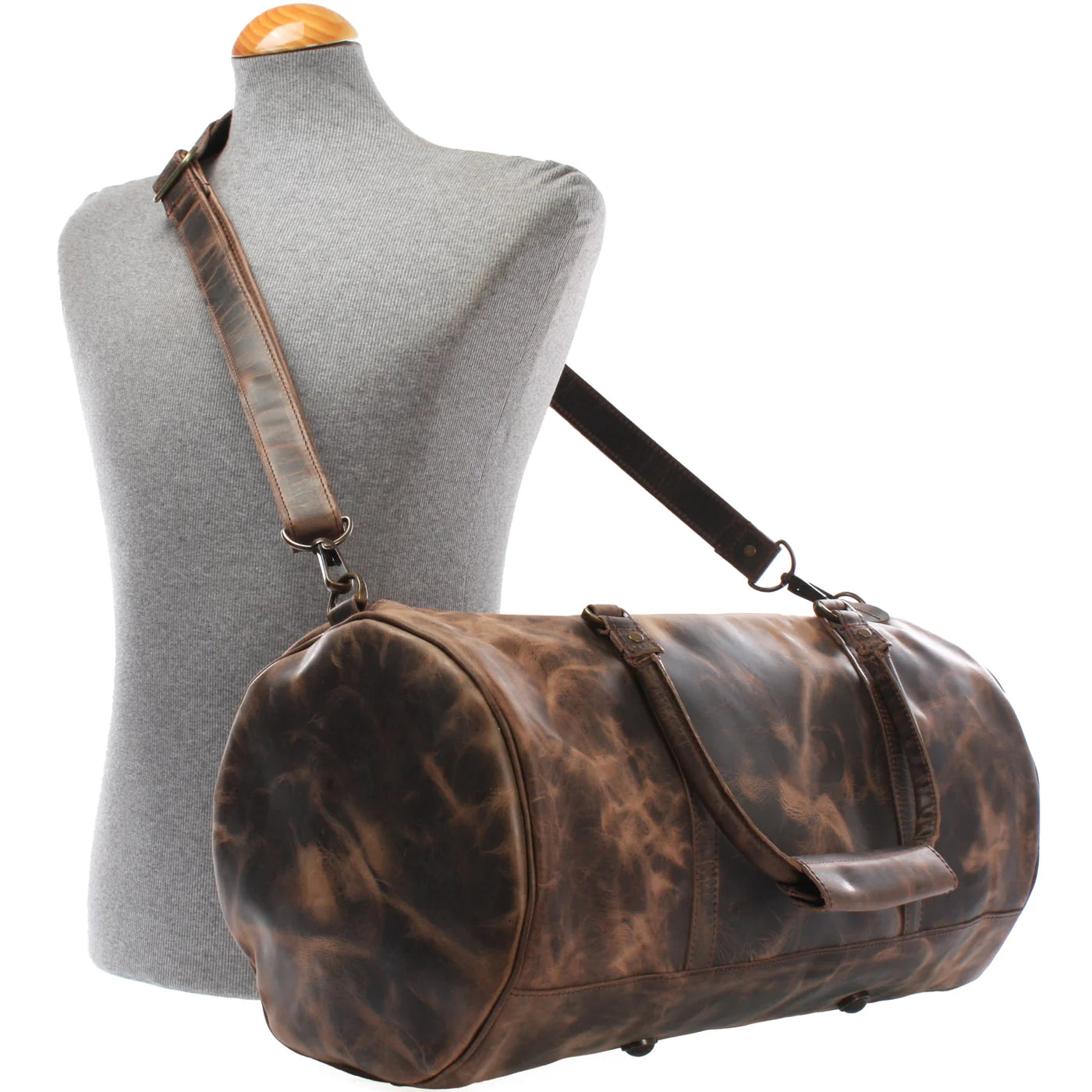 Mud brown Voyager leather weekender duffel displayed on a mannequin with detachable shoulder strap