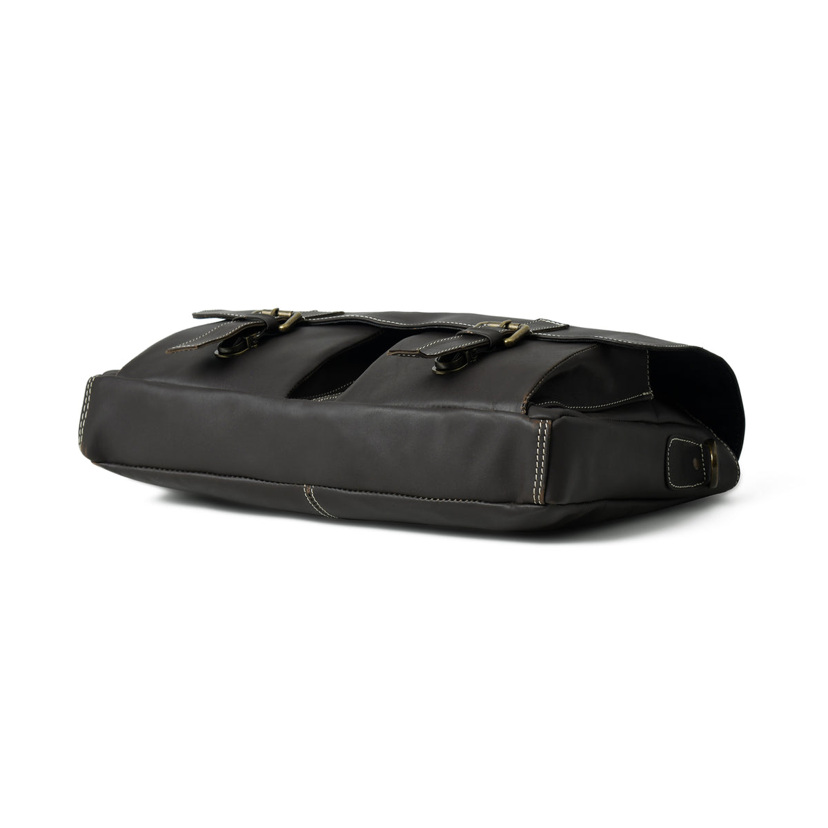 Black Maison leather briefcase laid flat, showing slim side profile, flap buckles, and reinforced base