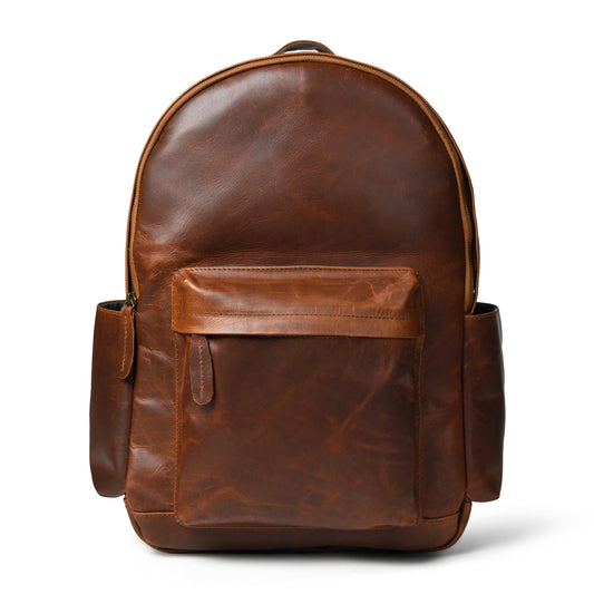 A brown distressed full grain handmade leather backpack with a front flap pocket and side pockets for college, travel and work or fathers day gift